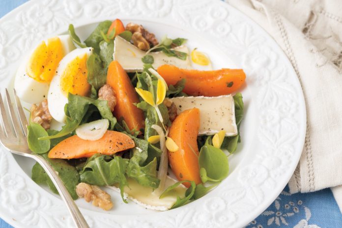 Walnuts, fennel, and soft-boiled eggs lend unexpected textural elements to a bed of baby arugula in Apricot-and-Brie Salad.