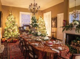 The dining room at Wakefield is decorated for the Christmas holidays with twin trees and a beautifully set table.