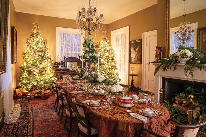 The dining room at Wakefield is decorated for the Christmas holidays with twin trees and a beautifully set table.