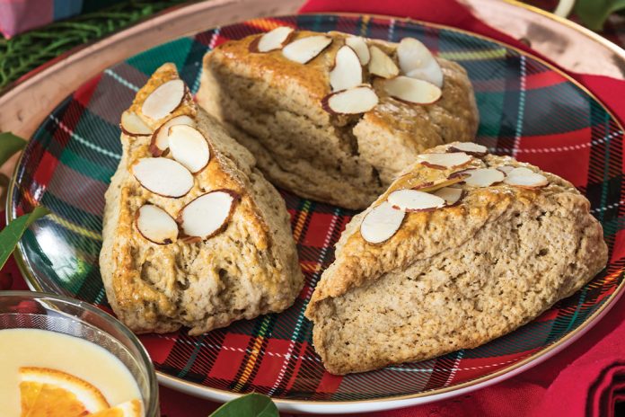 Resting atop a red-and-green plaid plate, our Gingerbread Almond Scones await indulgence.
