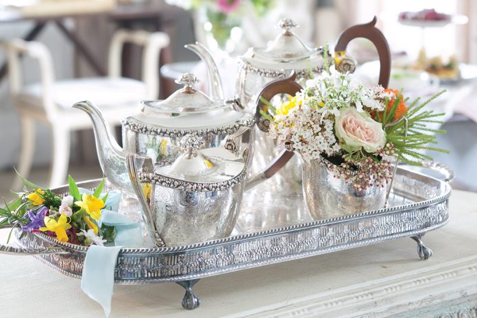 Teatime Bliss 2023 Preview Featured Silver Tea Service Alt Text: Set atop a silver tray, a silver tea set awaits the occasion.