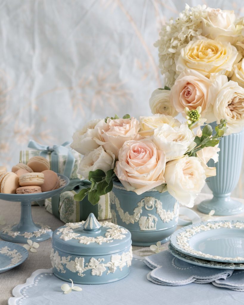 A bounty of white and blush pink roses spill from beautiful blue-and-white Wedgwood Queen’s Ware pieces.