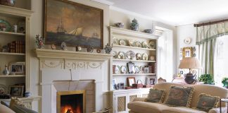 French antiques mingle in this stunning living room, where a cozy fire crackles in the hearth.